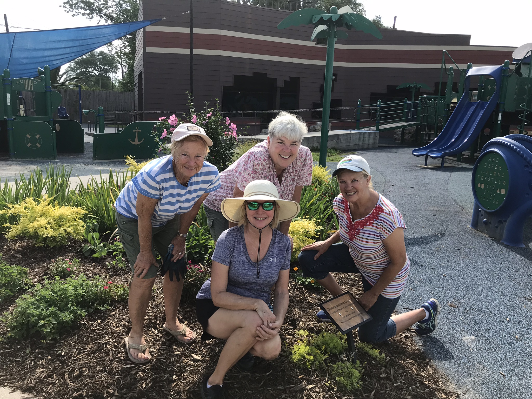 A group of four Ascension Master Gardeners at the Kidz Kove Discovery Park.